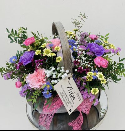 Bon Bon - Shower them with love with this cutesy collection of seasonal flowers in pretty pastels. Beautifully arranged and stylishly presented in a traditional basket.