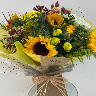 Sunshine Splendour - Radiate joy and warmth with this cheerful bouquet of sunflowers and lush greenery. Presented in a beautiful packaging, it's perfect for bringing a touch of sunshine into any space.