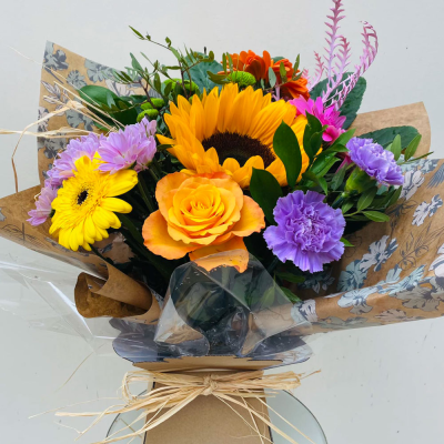 Bright Ideas - Beautiful Sunflowers and a peppering of other summer flowers and foliage. Tied in water and presented in a stylish bag. An amazing bouquet full of joy and delight ready to display and enjoy.