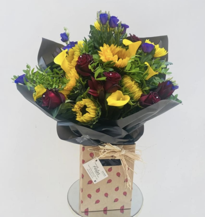 Sunflower Elegance - Brighten someone's day with this stunning arrangement featuring radiant sunflowers, roses, and calla lilies. This bouquet is perfect for any occasion, spreading cheer and positivity with its sunny colours.